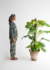 A woman wearing Beach Palm silk pajama set – tropical women’s sleepwear by LaRosa
